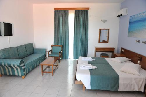a hotel room with a bed and a couch at Maritime in Kremasti