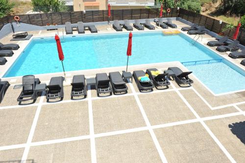 an overhead view of a swimming pool with lounge chairs and a pool at Maritime in Kremasti