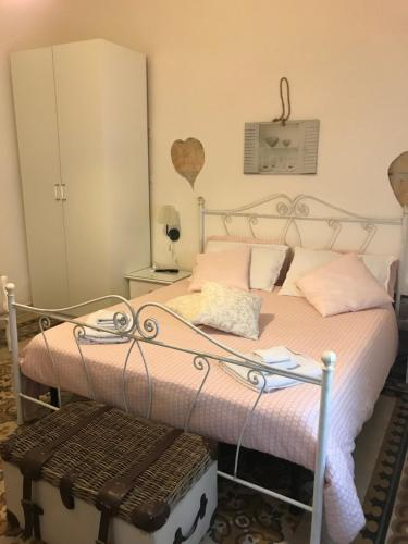 a bedroom with a bed with pink pillows at B&B La Villetta Palese in Bari