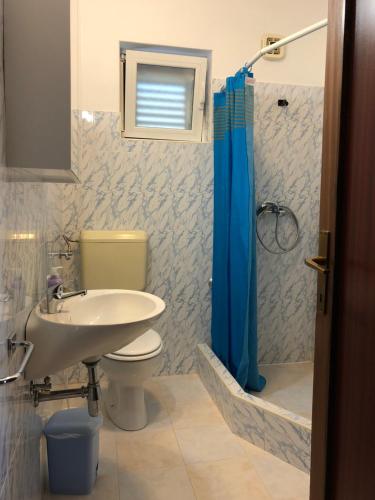 a bathroom with a sink and a toilet and a shower at Apartman ENA in Opatija