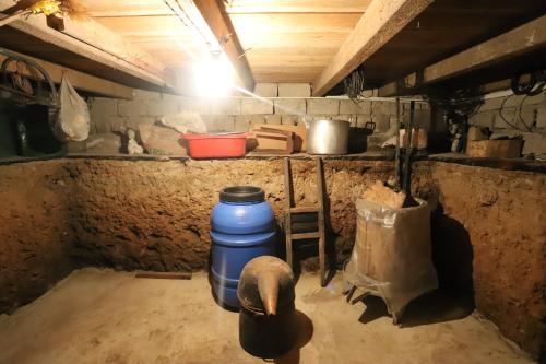 a room with a large blue barrel in a kitchen at Papazo in Kutaisi