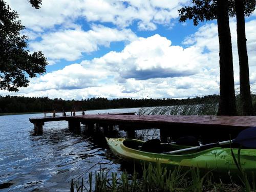 a boat is parked next to a dock at Dwa Pomosty in Augustów
