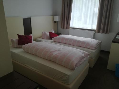 two beds sitting next to each other in a room at Zeesener Gasthof in Königs Wusterhausen