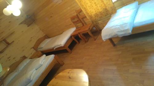 an overhead view of a bedroom with two beds and a table at Kempings Mežmalas in Usma