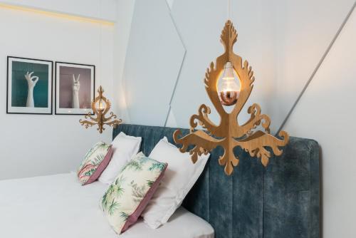 a room with a couch with pillows and a lamp at Nyx Chic Manor in Chania Town