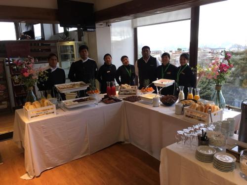 a group of people standing around a table with food at Hotel HF in Farellones
