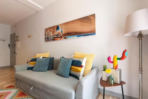 バルセロナにあるInBarcelonaSuitesのリビングルーム(カラフルな枕とソファ付)