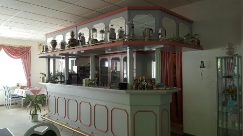 a large shelf with vases on it in a room at Pension Waldfrieden in Wolkenstein