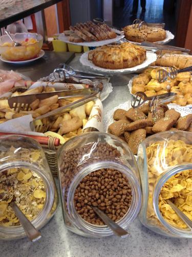 a table topped with lots of different types of food at Hotel Sandra in Gatteo a Mare