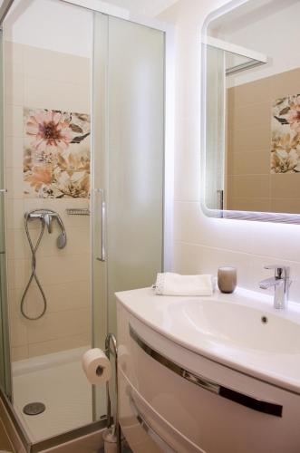 a bathroom with a sink and a shower at Guesthouse Ruža in Senj