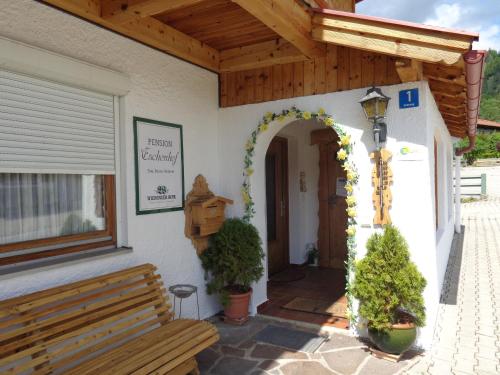 a porch of a building with a bench at Gästehaus Eschenhof in Reit im Winkl