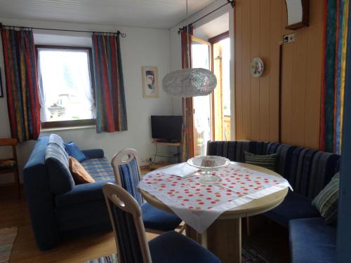 a living room with a table and chairs at Gästehaus Eschenhof in Reit im Winkl