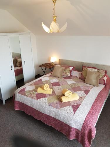 a bedroom with a bed with towels on it at Penzion Lamberk in Nový Jičín