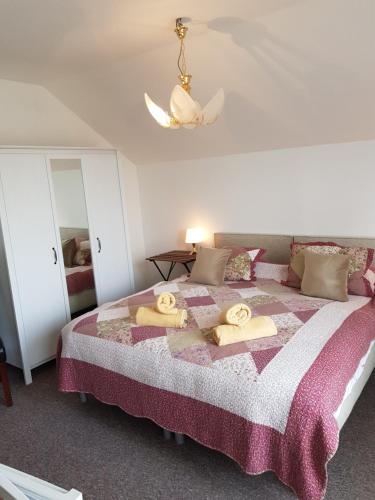 a bedroom with a bed with towels on it at Penzion Lamberk in Nový Jičín
