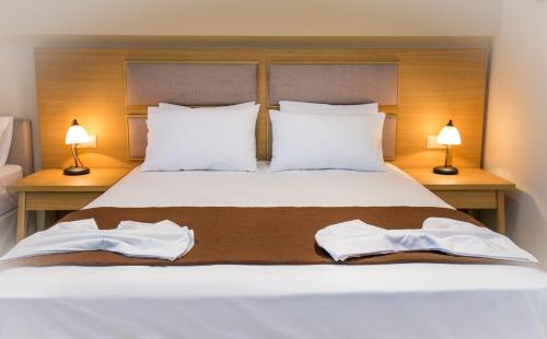 a bedroom with a bed with two towels on it at Villa Katerina in Potos