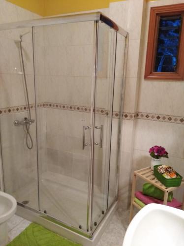 a shower with a glass door in a bathroom at Apartamentos La Banda in Playa de Santiago