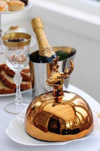 a gold container with a picture of a house on a plate at Inn on the Lake in Broek in Waterland