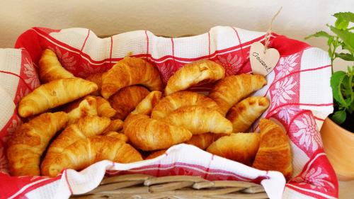 a basket of croissants in a red and white at Adventure Hostel Interlaken in Interlaken