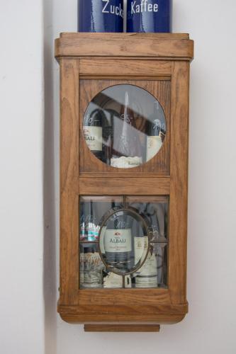 a wooden medicine cabinet with a mirror in it at Penzion Signum Laudis in Velké Hamry