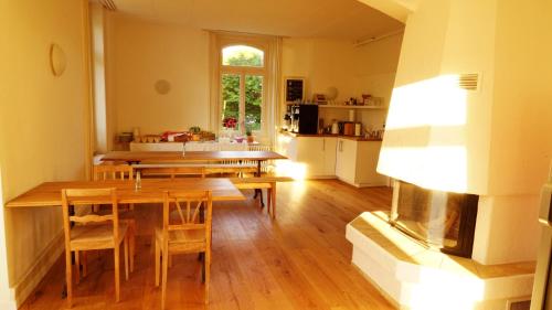 a kitchen and dining room with a table and chairs at Adventure Hostel Interlaken in Interlaken