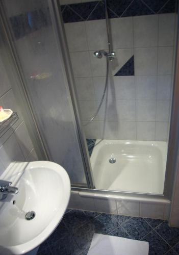 a bathroom with a shower and a sink and a tub at Hotel Deutsches Haus in Kaub