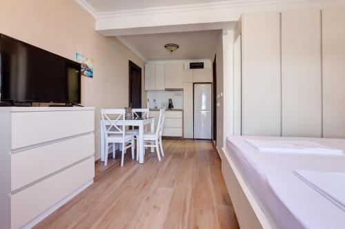 a kitchen and dining room with a table and chairs at Apartments PROVA in Sveti Stefan