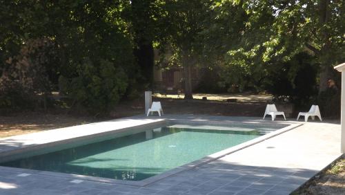 卡瓦永的住宿－Lou Jas d'Aimé，游泳池旁设有两把草坪椅