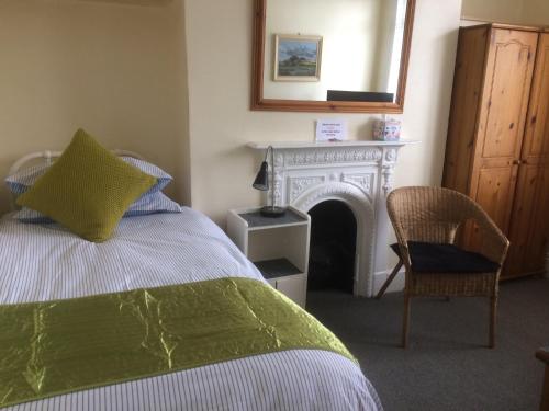 a bedroom with a bed with a fireplace and a mirror at Bay Lodge in Aylesbury