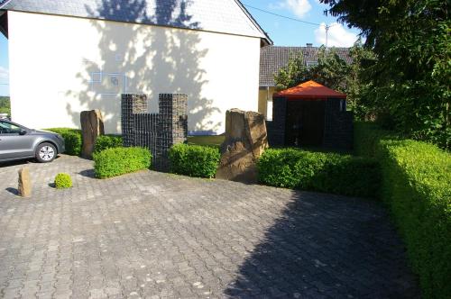 a brick walkway with a red tent next to a building at fewogriebelschied in Griebelschied