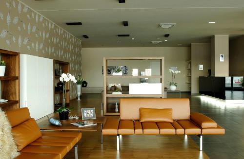 a living room with a couch and a table at G Hotel Ancona in Osimo