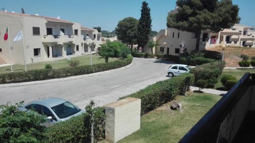 a view of a street with cars parked on the road at Casa Alvor in Alvor
