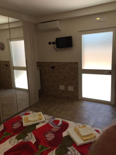 a living room with a large window and a television at Beb la lupa in Rome
