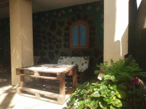 a wooden table and a chair on a patio at Bozhur Guest House in Odesa