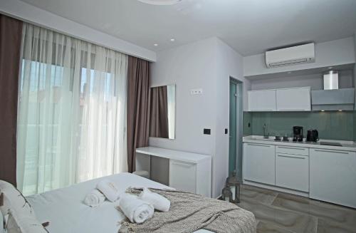 a bedroom with a bed with towels on it at Imagine Studios in Paliouri