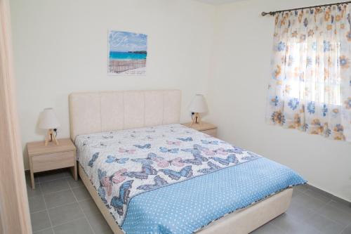 a bedroom with a bed and two night stands at House for Relaxing Vacations in Keramoti