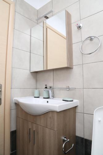 a bathroom with a sink and a mirror at House for Relaxing Vacations in Keramoti