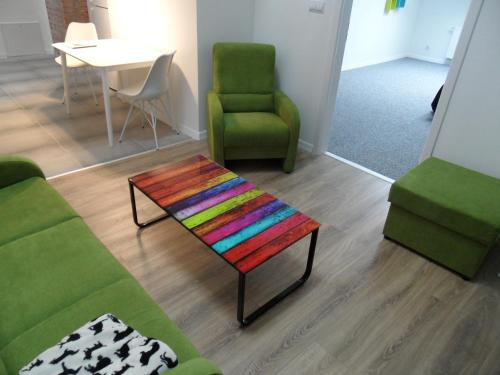 a living room with a couch and a table and chairs at Klimatyczny apartament przy bocheńskim Rynku. in Bochnia