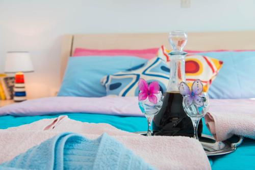 a table with two wine glasses on a bed at Kyprianos house in Platis Yialos Sifnos