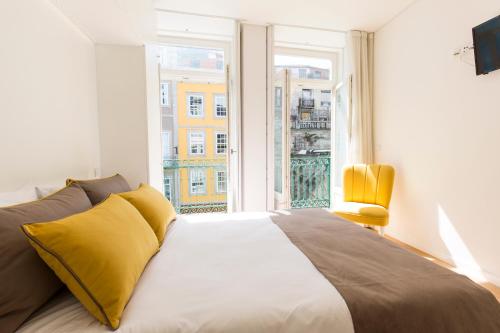 a bedroom with a large bed and a large window at Downtown Porto Mouzinho Studio Apts in Porto