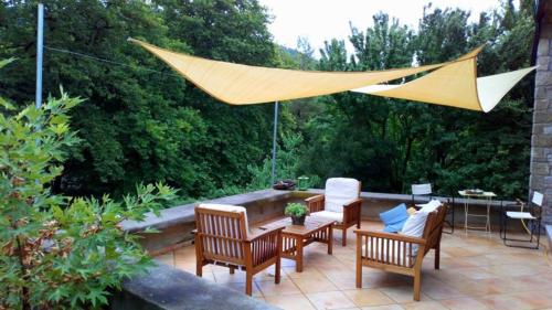 a patio with chairs and a table and a hammock at Pili Country House in Pili
