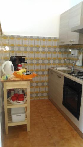 a kitchen with a counter with a sink and a stove at Gli Ulivi di Nesso in Nesso