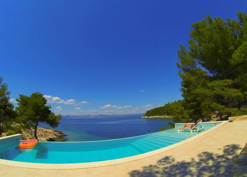 a swimming pool with a view of the water at Holiday house Karla in Vela Luka