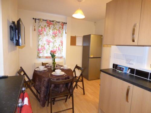 a kitchen with a table with chairs and a dining room at Birdholme House in Chesterfield