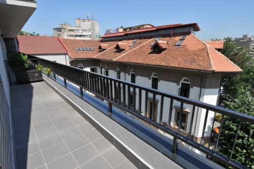 a balcony of a building with a red roof at Hotel Hemingway Residence in Bucharest