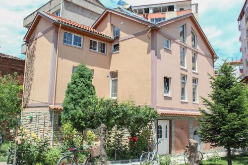 a large building with trees in front of it at Vila Topciu in Pogradec