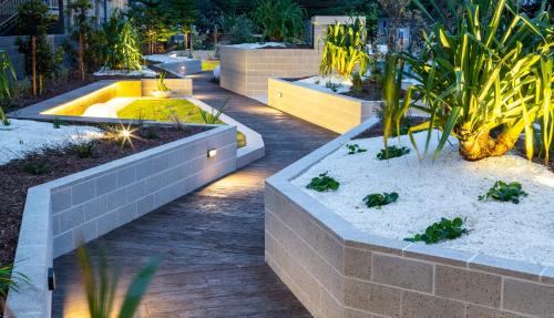 a garden with two planters with plants in it at Boardwalk Burleigh Beach - Official in Gold Coast