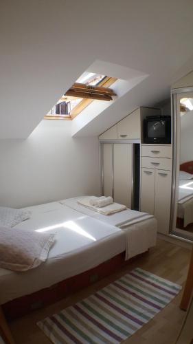 a bedroom with a bed and a skylight at Apartments Iva und Franka in Omiš