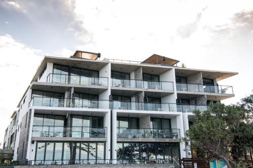an apartment building with balconies on it at The Sebel Brisbane Margate Beach in Redcliffe