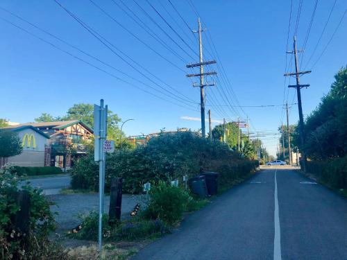 an empty street with utility poles on the side of the road at Boutique in Vancouver