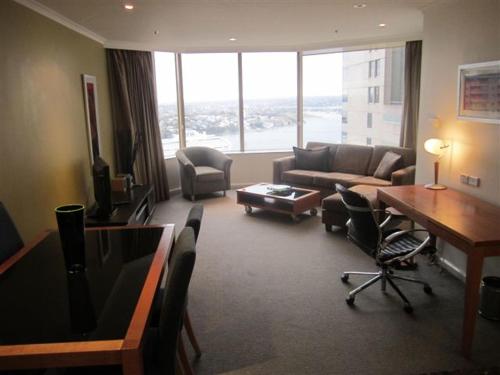 a living room with a couch and a table at Quay West 2007- Self Catering in Sydney